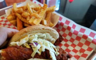 Chicken Slider with fries and coleslaw inside a food basket